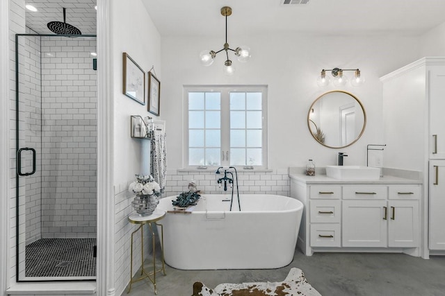 bathroom with vanity, tile walls, a chandelier, and plus walk in shower