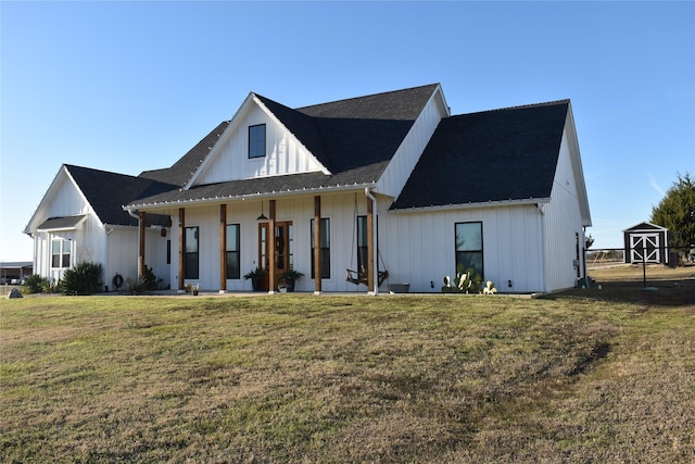 modern inspired farmhouse with french doors, a front lawn, and a shed