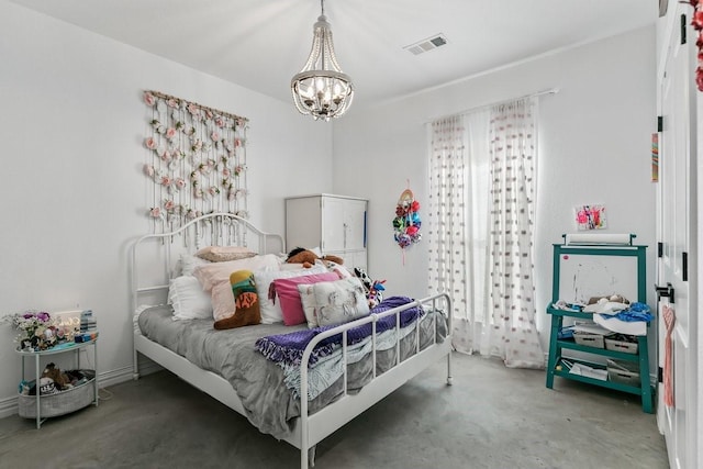 bedroom featuring concrete floors and a notable chandelier