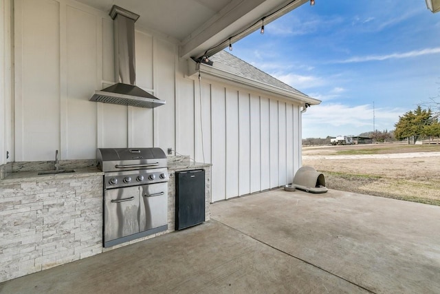 view of patio featuring sink, a grill, and exterior kitchen