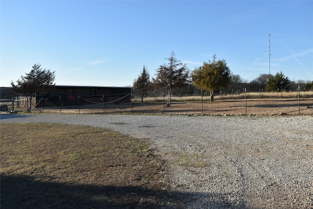 view of yard featuring a rural view and an outbuilding