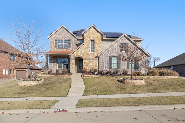 view of front of home with a front lawn, solar panels, and a garage