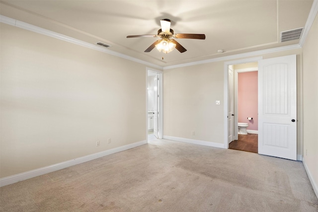 spare room featuring ceiling fan, light colored carpet, and ornamental molding