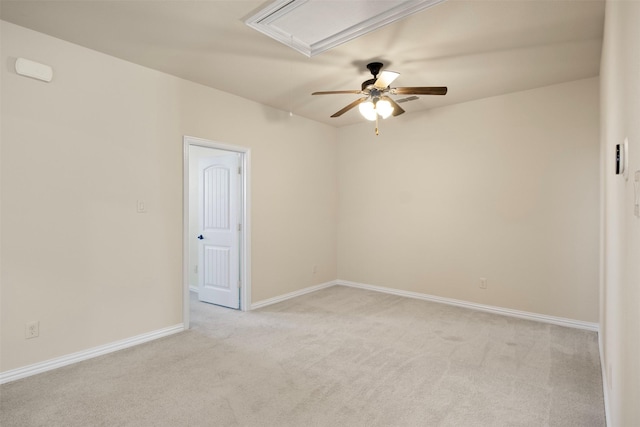 spare room featuring light colored carpet and ceiling fan