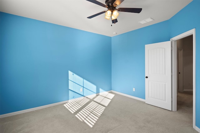 carpeted empty room featuring ceiling fan