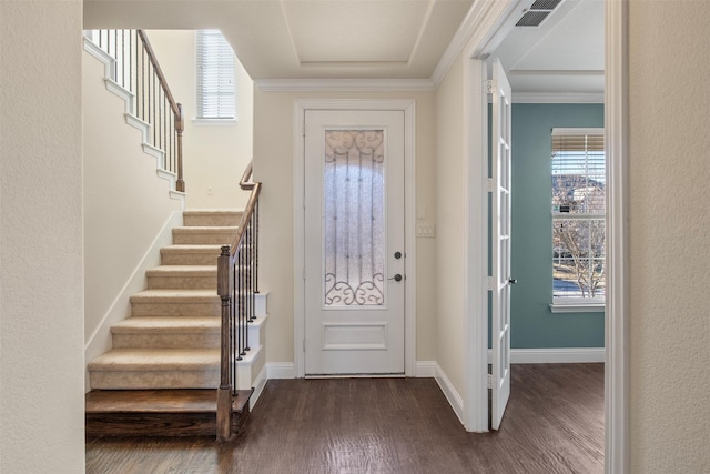 entrance foyer with crown molding and dark wood-type flooring