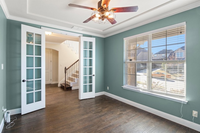 empty room featuring french doors, dark hardwood / wood-style flooring, ceiling fan, and crown molding