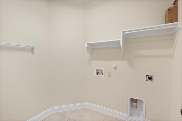 laundry area featuring gas dryer hookup, hookup for a washing machine, light tile patterned floors, and hookup for an electric dryer