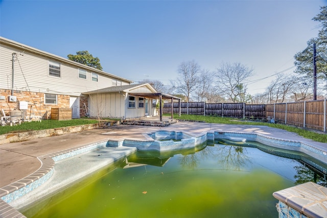 view of pool featuring a patio area and an in ground hot tub