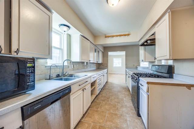 kitchen with black appliances, ventilation hood, sink, light tile patterned floors, and tasteful backsplash