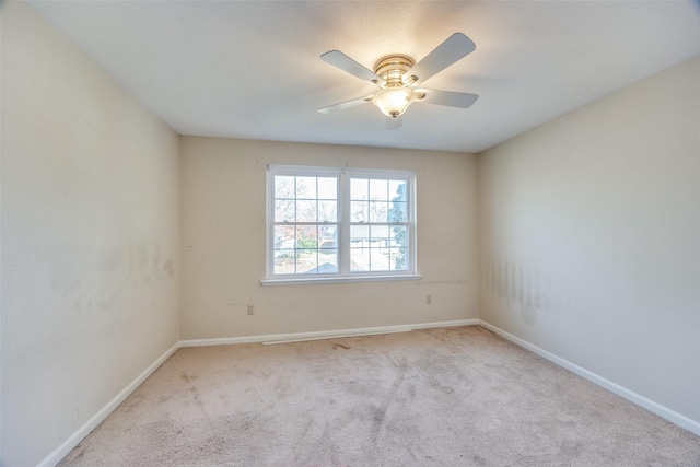 unfurnished room with ceiling fan and light colored carpet