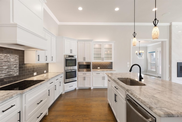 kitchen featuring crown molding, white cabinets, dark wood-type flooring, stainless steel appliances, and a sink
