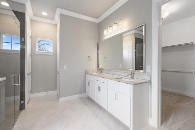 bathroom featuring double vanity, baseboards, a sink, and ornamental molding