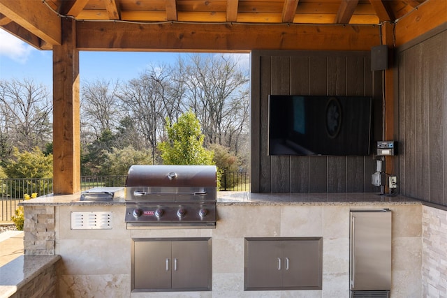 view of patio with a gazebo, an outdoor kitchen, fence, and area for grilling