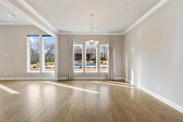 unfurnished dining area with a chandelier, wood finished floors, and a healthy amount of sunlight