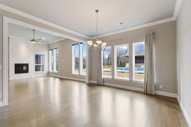 interior space with baseboards, an inviting chandelier, crown molding, visible vents, and wood finished floors