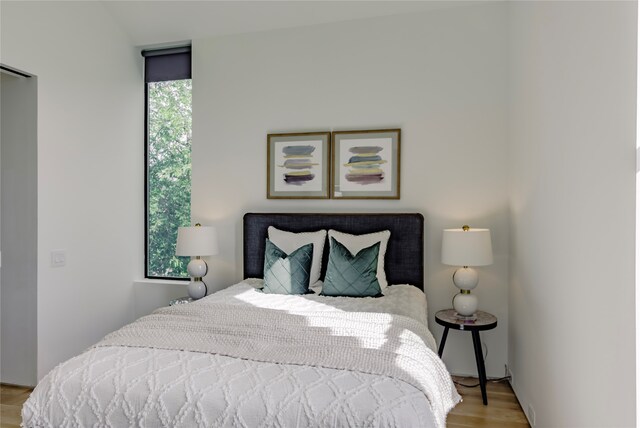 bedroom with light hardwood / wood-style flooring and multiple windows