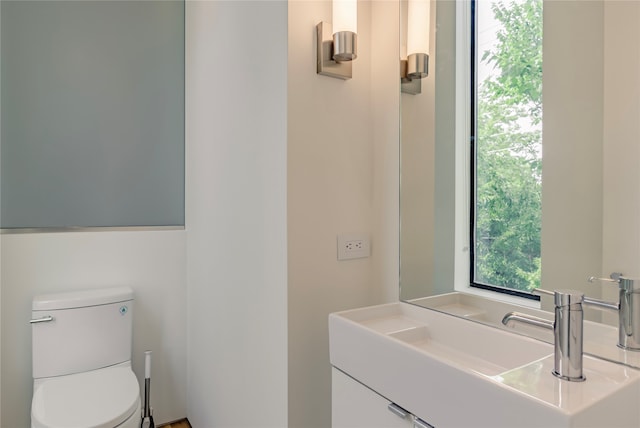 bathroom featuring toilet and vanity