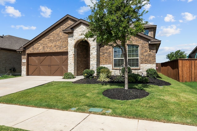 view of front of property featuring a garage and a front lawn