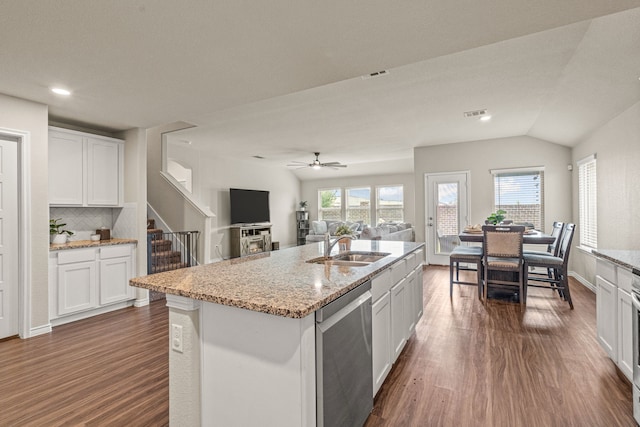 kitchen with white cabinetry, dishwasher, an island with sink, and vaulted ceiling