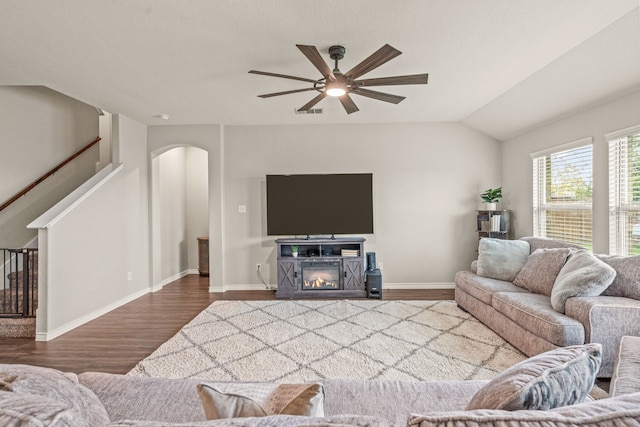 living room with hardwood / wood-style floors, vaulted ceiling, and ceiling fan