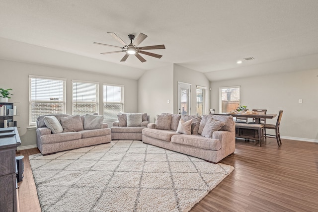 living room featuring light hardwood / wood-style floors, ceiling fan, and lofted ceiling