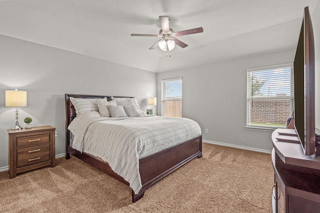 carpeted bedroom with multiple windows, ceiling fan, and lofted ceiling