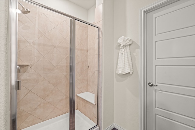 bathroom with a shower with shower door