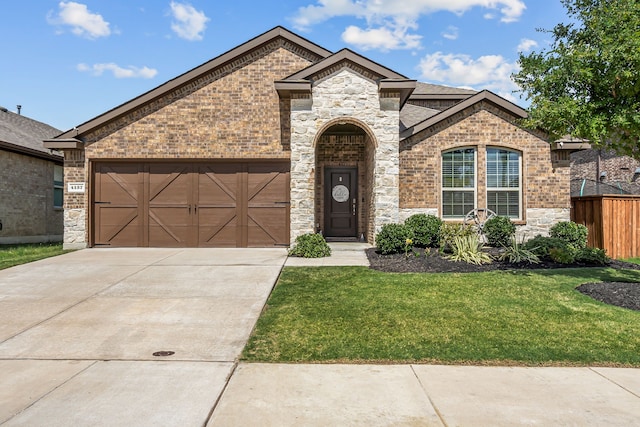 view of front of house featuring a front yard and a garage