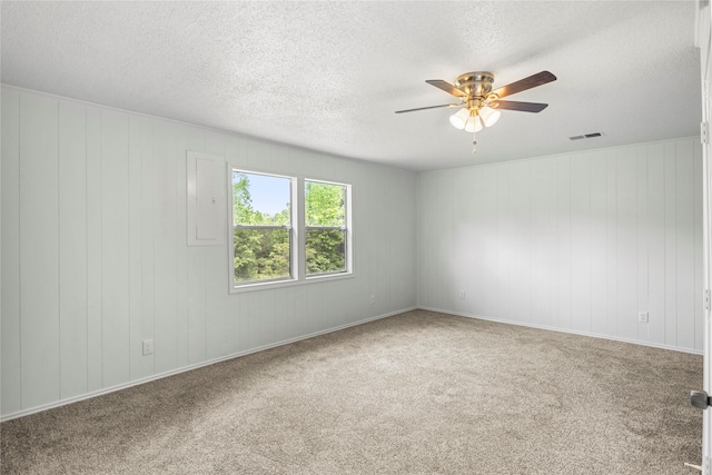 empty room with carpet, a textured ceiling, and ceiling fan