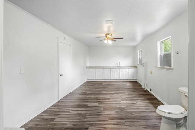 spare room featuring ceiling fan, dark hardwood / wood-style flooring, and sink