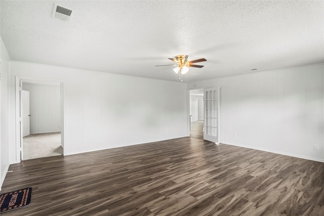 unfurnished room featuring a textured ceiling, ceiling fan, and dark hardwood / wood-style floors