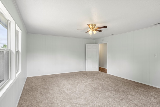 unfurnished room with carpet, plenty of natural light, and ceiling fan