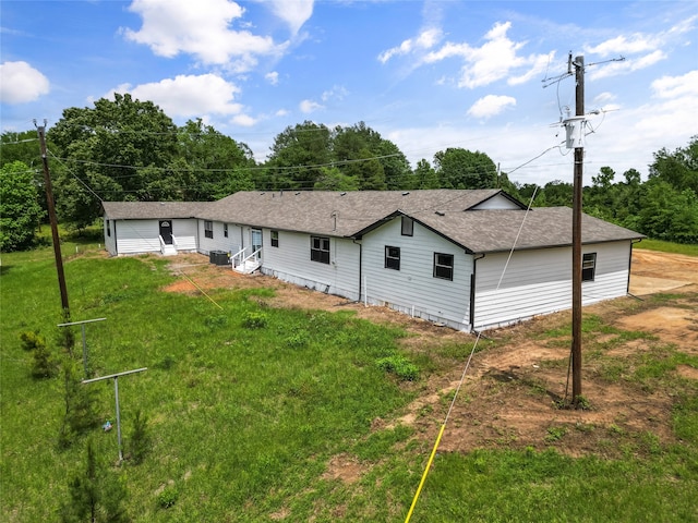 rear view of house featuring a yard