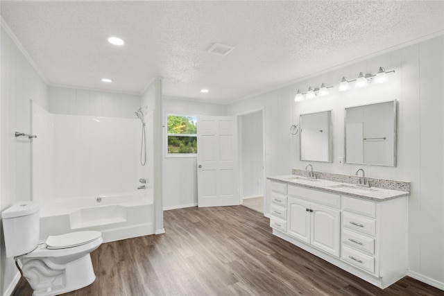 full bathroom with hardwood / wood-style flooring, ornamental molding, shower / bath combination, and toilet