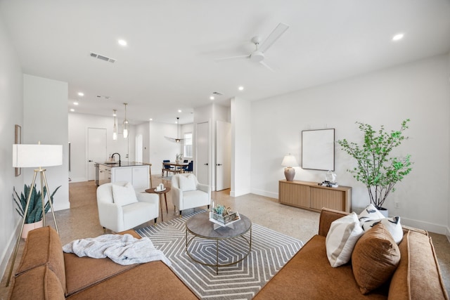 living room featuring ceiling fan and sink