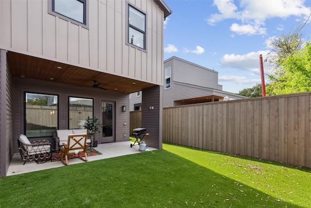 back of house featuring a patio, ceiling fan, and a lawn