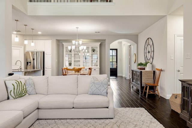 living room with sink and dark wood-type flooring