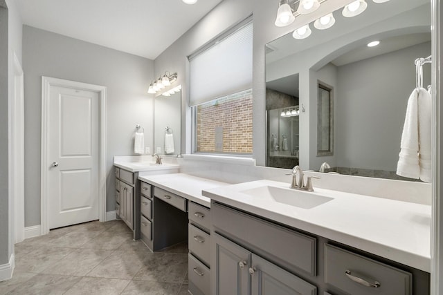 bathroom featuring tile patterned floors, vanity, and an enclosed shower