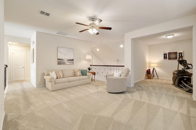 carpeted living room with ceiling fan