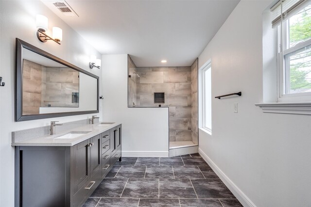 bathroom featuring vanity and tiled shower