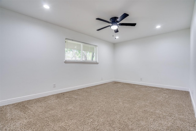 carpeted spare room featuring ceiling fan