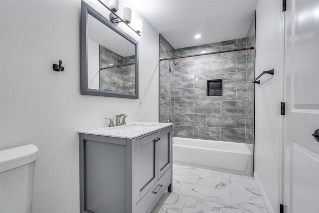 full bathroom with vanity, toilet, and tiled shower / bath combo