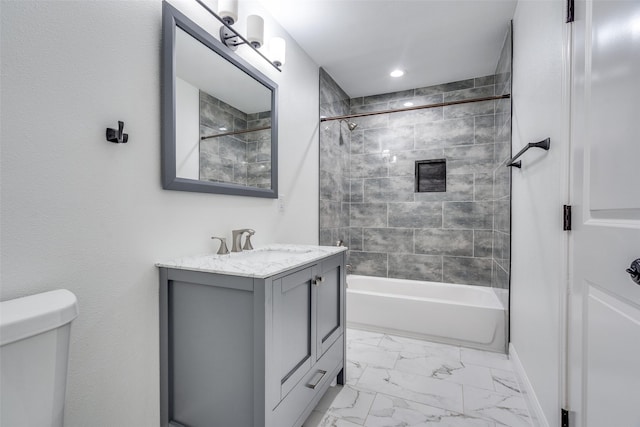 full bathroom featuring vanity, tiled shower / bath combo, and toilet