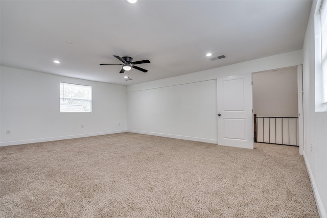 carpeted spare room with ceiling fan