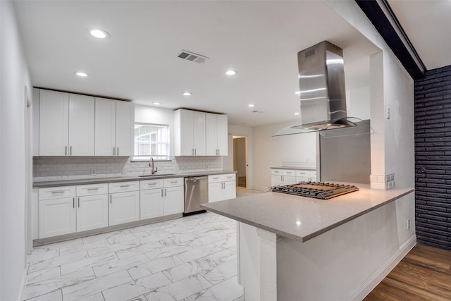 kitchen featuring island exhaust hood, white cabinets, and stainless steel appliances