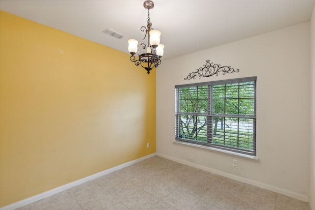 spare room with an inviting chandelier