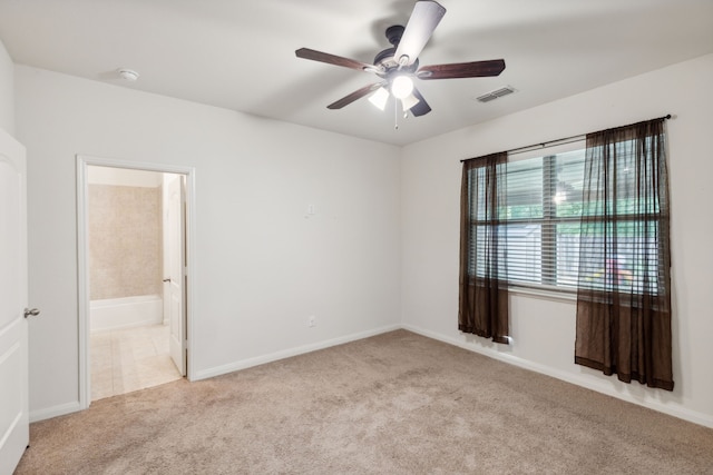 empty room featuring light colored carpet and ceiling fan