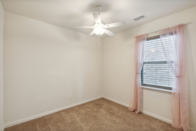 spare room with light carpet and ceiling fan