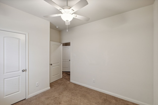 unfurnished bedroom with light carpet and ceiling fan